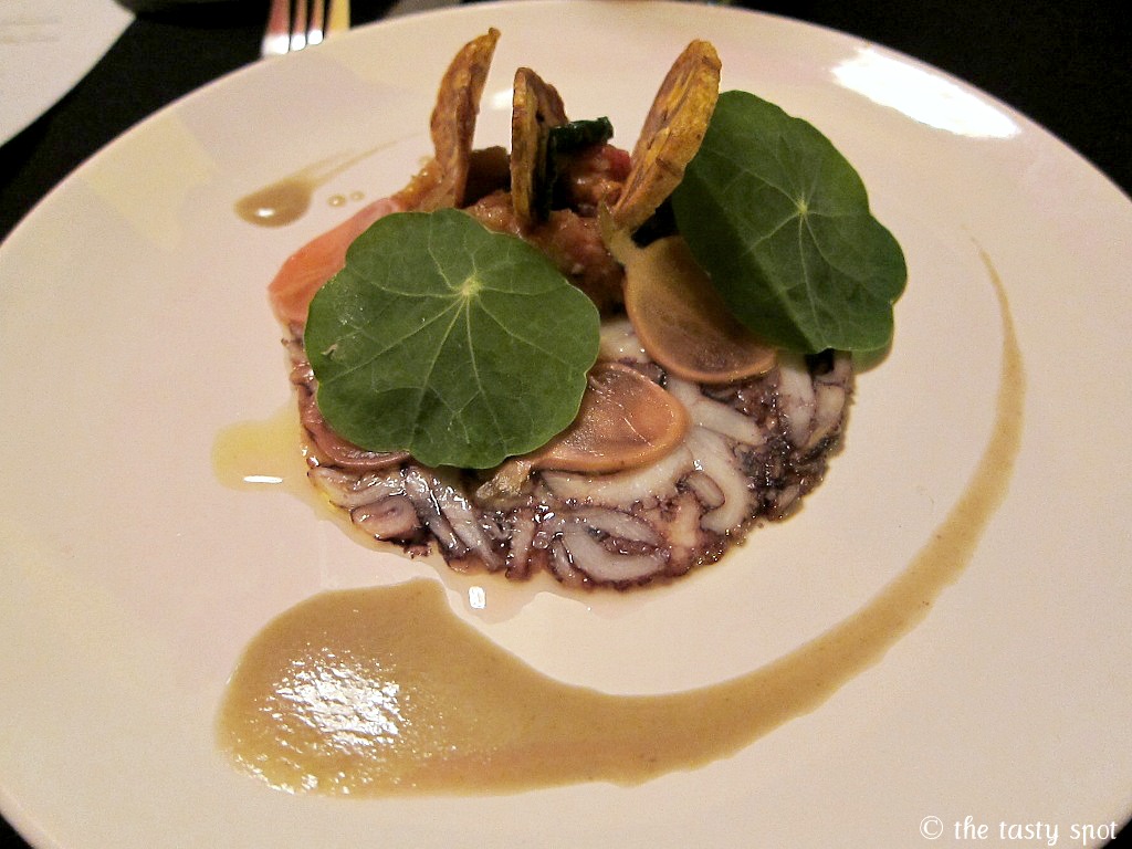 Octopus with green banana, betelnut leaves, tomato confit, watercress, and octopus jus